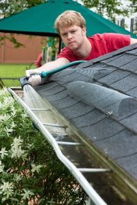 Man cleaning his gutters