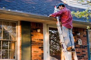 A man cleaning his gutters.