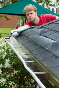 A man cleaning his gutters.