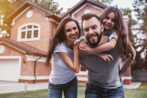 A family outside of a house.