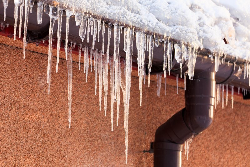 A frozen and snow-filled gutter.