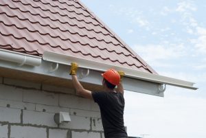 man installing gutters