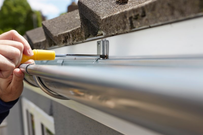 man installing gutter flashing