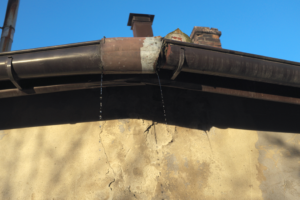 a closeup of a leaky old gutter