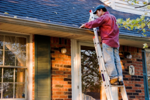 a person cleaning their gutters