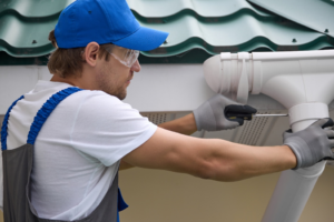 a person installing a gutter system