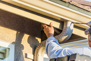 a worker installing a gutter system